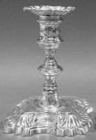 A typical George II cast candlestick with cut corned ribbed base and cast and chased decoration - London 1755 William Gould