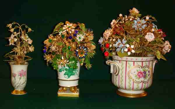 containers used for the flower arrangements contribute additional charm